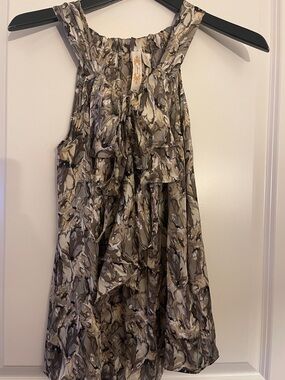 A Diva sleeveless top with a ruffle in a Leopard print style